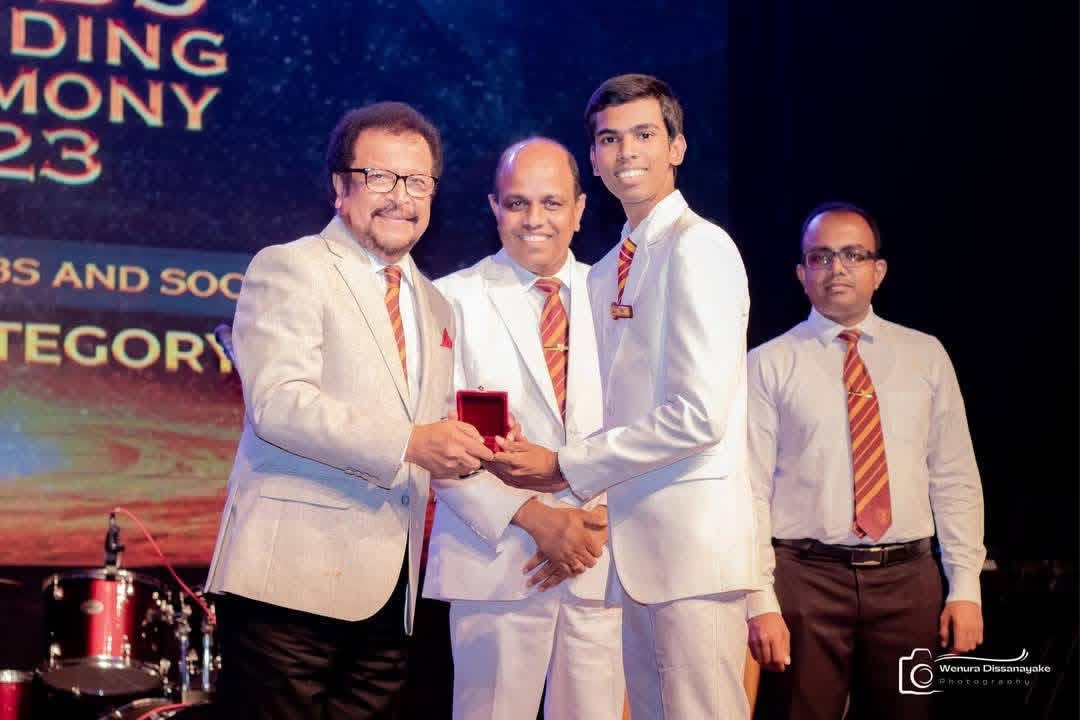 Ramika Risiwara receiving an award on stage