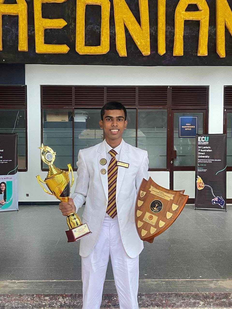 Ramika Risiwara holding a trophy and championship shield
